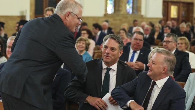 It’s elbows out as Scott Morrison greets Anthony Albanese at a parliamentary service at St Christopher’s Cathedral in Manuka. Picture: Getty Images