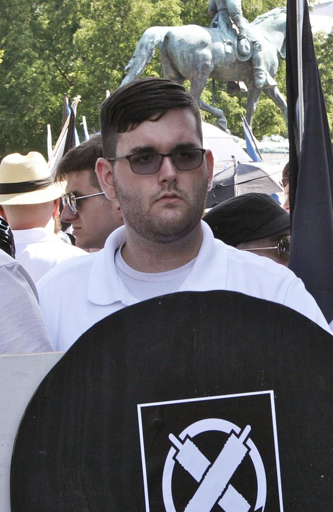 James Alex Fields Jr, left, holds a black shield belonging to the White Supremacist group Vanguard America. Picture: Alan Goffinski/AP