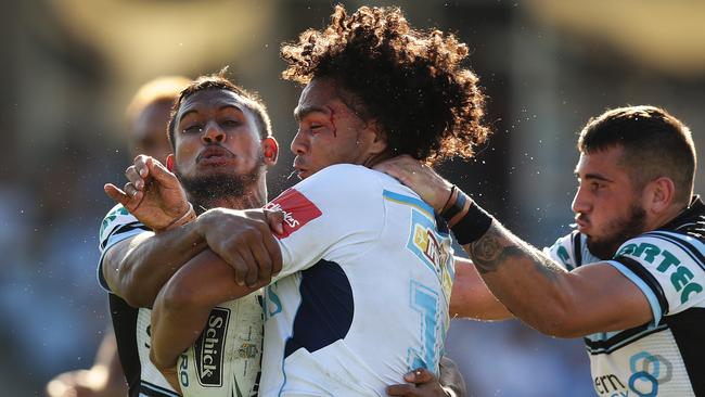 Titans Leivaha Pulu is tackled during the Cronulla Sharks v Gold Coast Titans rugby league game at Shark Park, Cronulla. Pic Brett Costello