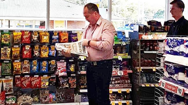 Barnaby Joyce reads the <i>Daily Telegraph </i>in a service station this morning ahead of his meeting with the PM. Picture: Supplied