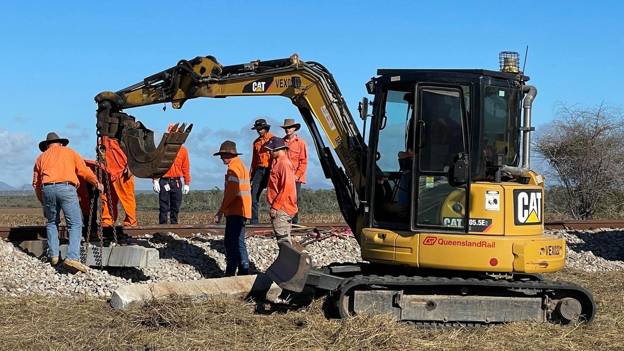 Crews repairing the damaged railway line the morning after a triple fatal crash involving a bus and car towing a caravan along the Bruce Highway in Gumlu on Sunday. Picture: Leighton Smith
