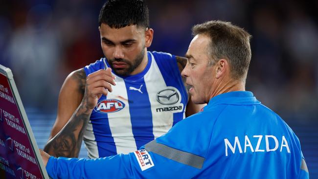 MELBOURNE, AUSTRALIA – AUGUST 12: Alastair Clarkson, Senior Coach of the Kangaroos speaks with Tarryn Thomas during the 2023 AFL Round 22 match between the North Melbourne Kangaroos and the Essendon Bombers at Marvel Stadium on August 12, 2023 in Melbourne, Australia. (Photo by Michael Willson/AFL Photos via Getty Images)