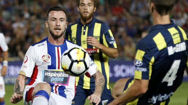 Roy O'Donovan of the Jets controls the ball in front of the Mariners’ Jake McGing on Saturday night.