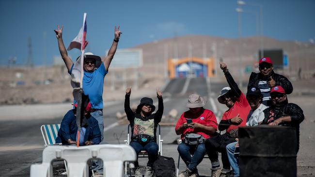 (FILES) This file photo taken on March 08, 2017 shows miners of the Escondida copper mine, on strike, blocking a road outside of Escondida, some 145km northeast of Antofagasta, Chile, on March 8. (Picture: AFP/ Martin BERNETTI)