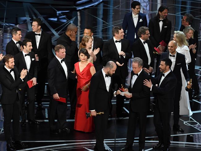 'La La Land' producer Jordan Horowitz holds up the winner card reading actual Best Picture winner 'Moonlight' with actor Warren Beatty and host Jimmy Kimmel onstage. Picture: Getty