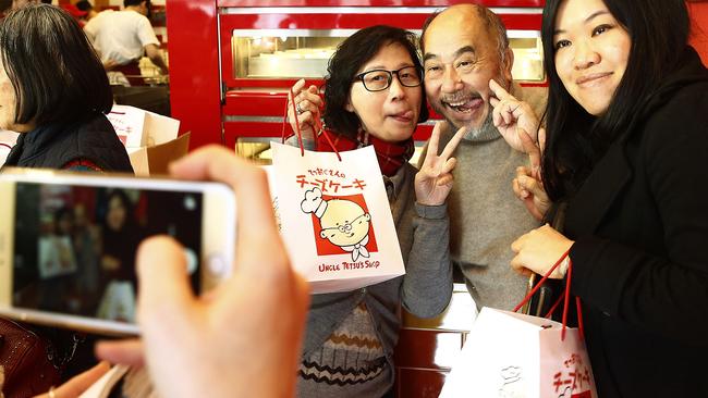 Uncle Tetsu poses for a photo with Fans Imelda Chan and Emily Liang. Picture: John Appleyard
