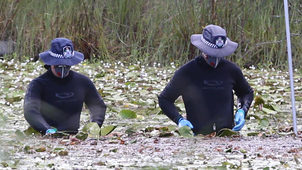 Police search the dam where the pair were dumped. Jono Searle.