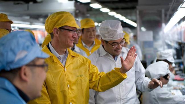 This handout picture released by Apple shows Apple chief executive Tim Cook visiting the iPhone production line at the newly built Foxconn manufacturing facility at Zhengzhou Technology Park in the city of Zhengzhou in China's north-central Henan province in 2012.