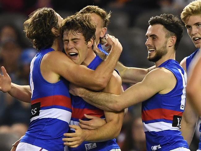 Josh Dunkley of the Bulldogs (second from left) reacts after kicking a goal during the Round 13 AFL match between the Carlton Blues and the Western Bulldogs at Marvel Stadium in Melbourne, Saturday, June 15, 2019.  (AAP Image/Julian Smith) NO ARCHIVING, EDITORIAL USE ONLY