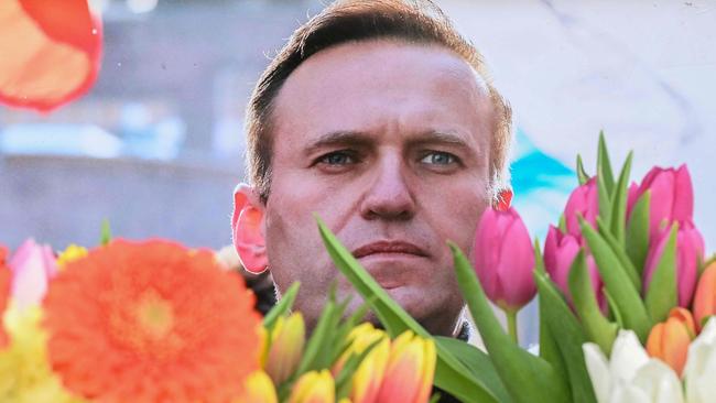 Flowers are seen placed around portraits of late Russian opposition leader Alexei Navalny. Picture: AFP