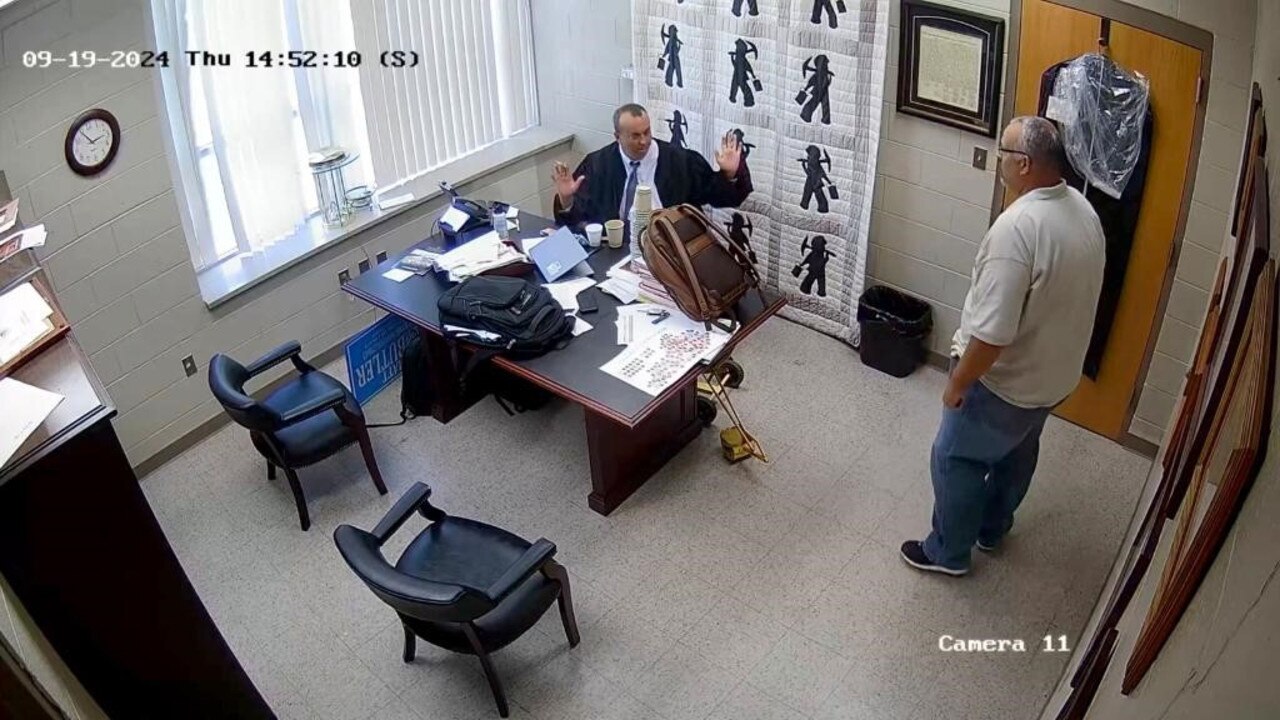 Footage shows Letcher County Sheriff Shawn Stines pointing his gun at District Judge Kevin Mullins after what appeared to be a heated exchange. Picture: KY Courts