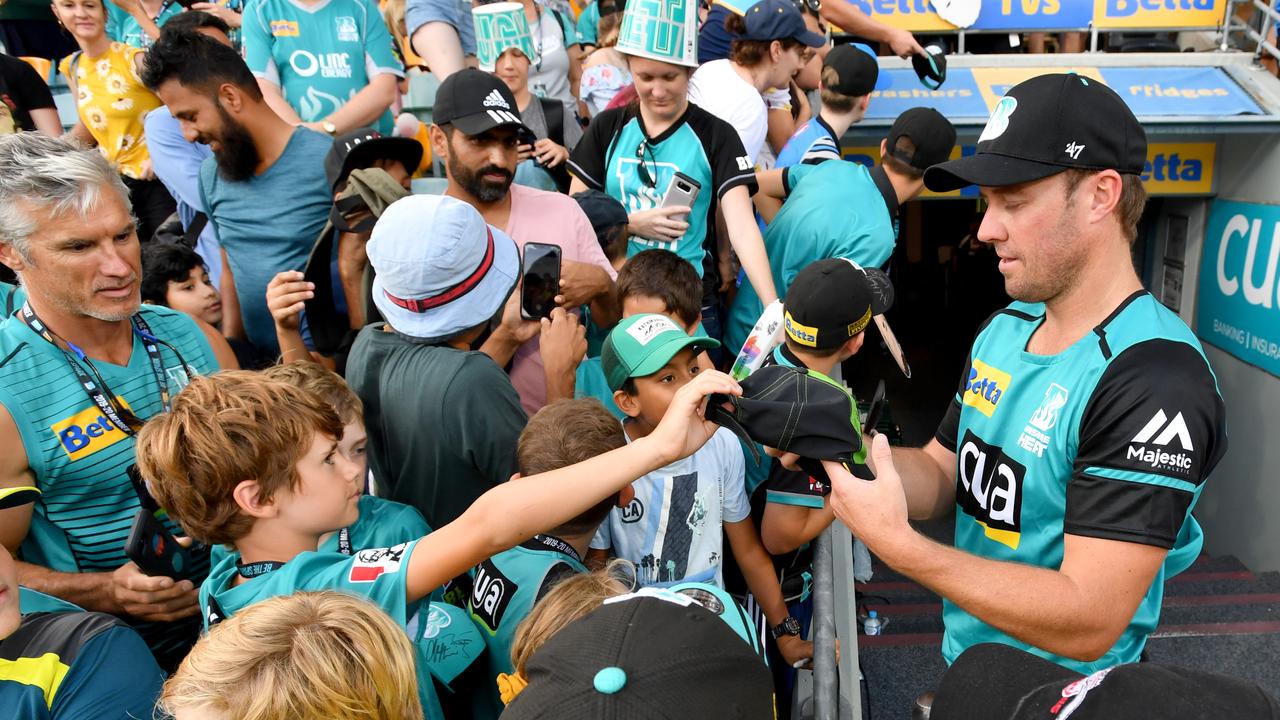 AB de Villiers (right) is mobbed by fans ahead of his BBL debut for Brisbane Heat.