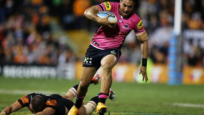 Penrith's Dean Whare beats Tigers Kyle Lovett to set up a try for David Simmons. Pic Brett Costello