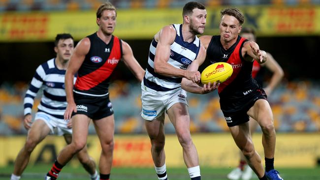 Sam Menegola of the Cats makes a handpass during the Round 16 AFL match against the Bombers. Picture: Getty Images