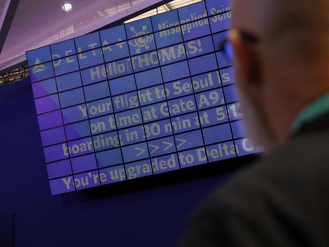 An attendee looks at a screen with information unique to him at the Delta Air Lines booth at CES. Picture: AP.