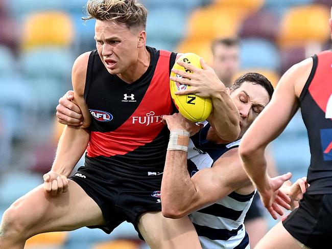 BRISBANE, AUSTRALIA - SEPTEMBER 06: Dylan Clarke of the Bombers attempts to break away from the defence during the round 16 AFL match between the Geelong Cats and the Essendon Bombers at The Gabba on September 06, 2020 in Brisbane, Australia. (Photo by Bradley Kanaris/Getty Images)