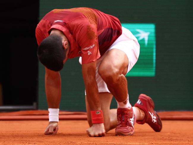 TOPSHOT - Serbia's Novak Djokovic reacts after falling on the court during his men's singles round of sixteen match against Argentina's Francisco Cerundolo on Court Philippe-Chatrier on day nine of the French Open tennis tournament at the Roland Garros Complex in Paris on June 3, 2024. (Photo by Emmanuel Dunand / AFP)