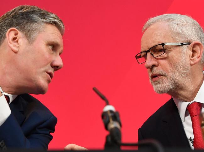 Opposition Labour Party leader Jeremy Corbyn (R) speaks with his shadow Brexit secretary Keir Starmer during a press conference in London. Photo by Ben STANSALL / AFP