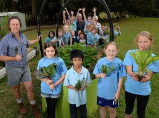 GREEN THUMBS: Pat Greene and the children of Goolmangar Primary School are preparing for the garden competition with the Lismore Garden Club. Students at the front are Odessa Smith, Christian Hertz, Audrey Jones and Cieda Ritchi-jol. At the back with the rest of the school are Charlie and Dorothy Cox, judges of the competiton. Picture: Mireille Merlet-Shaw