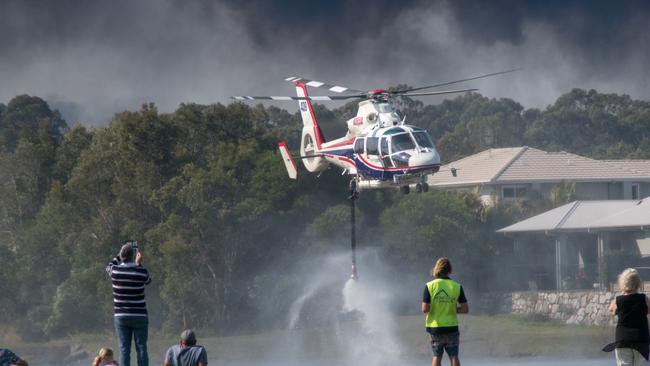 Helicopters taking on water to waterbomb the fire. The waterbombing at the Weyba Downs area, adjacent to Peregian Springs, Peregian Spring Golf Course. Picture: Ian Martin