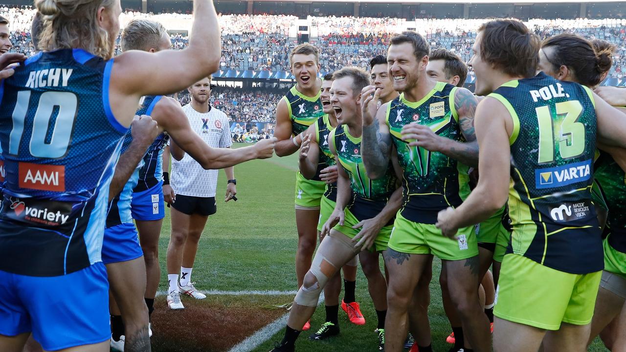 Players participate in rock, paper, scissors before the AFLX match between Team Bolts and Team Rampage.
