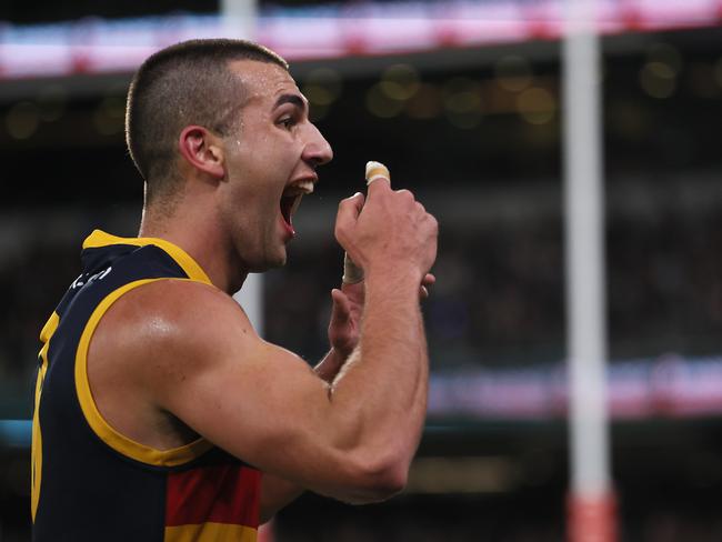 Josh Rachele of the Crows gestures to his teeth after scoring a goal in the Showdown. Picture: Getty Images