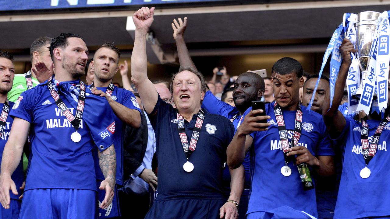 Cardiff City manager Neil Warnock and the Cardiff City players celebrate winning.