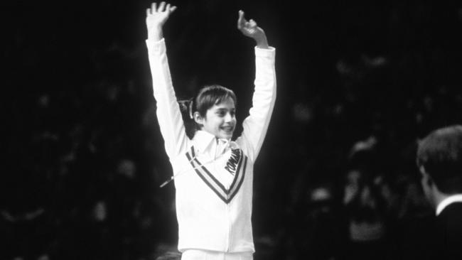 Romanian gymnast, Nadia Comaneci, the first to score a perfect ten, pictured collecting her gold medal for the women's gymnastics, all around competition, at the 1976 Montreal Olympic Games. Picture: News Corp