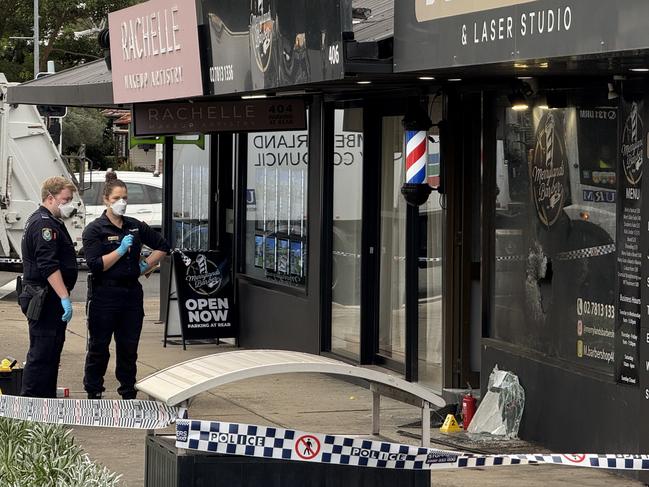 Forensics inspecting Merrylands Barber Shop on Merrylands Rd in Merrylands after a suspected arson attack with police believing a man caught alight while trying to set the shop alight. Picture