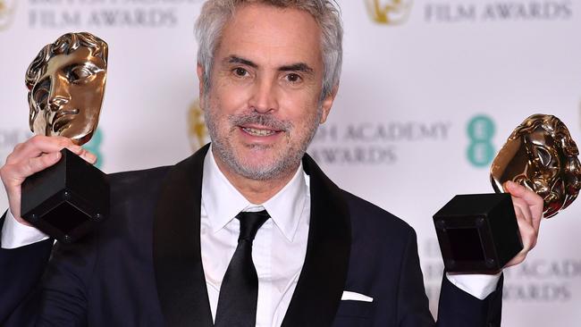 Mexican director Alfonso Cuaron with his Bafta awards. Picture: AFP.