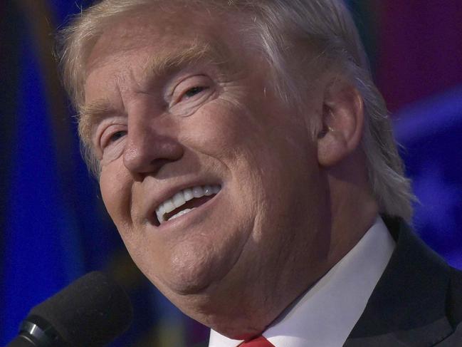 Republican presidential elect Donald Trump (L) gives a speech during election night at the New York Hilton Midtown in New York on November 9, 2016. Trump stunned America and the world Wednesday, riding a wave of populist resentment to defeat Hillary Clinton in the race to become the 45th president of the United States. / AFP PHOTO / MANDEL NGAN