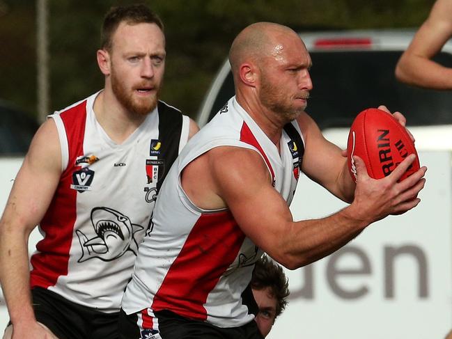 Bonbeach champion Shane McDonald has the ball as Sharks captain Jackson Casey looks on. Picture: Hamish Blair