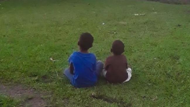 Two young boys watch the game. Picture: Teivovo Rugby