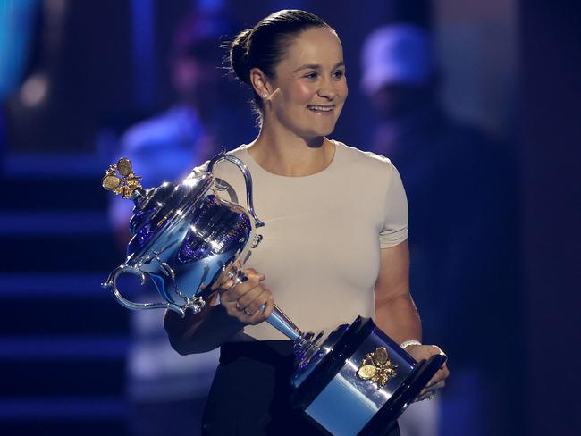 MELBOURNE, AUSTRALIA - JANUARY 14: Ash Barty walks the Daphne Akhurst Memorial Cup onto Rod Laver Arena during day one of the 2024 Australian Open at Melbourne Park on January 14, 2024 in Melbourne, Australia. (Photo by Julian Finney/Getty Images)