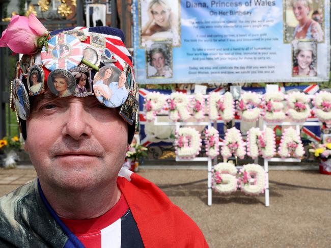 Royal fan John Loughrey stands with tributes to Princess Diana outside the gates of Kensington Palace on what would have been her 60th birthday. Picture: Getty Images