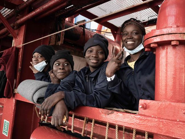 Migrants stand on board the Ocean Viking prior disembarking in Toulon on November 11, 2022, after being rescued by European maritime-humanitarian organization "SOS Mediterranee". - Migrant rescue group SOS Mediterranee said on November 3, 2022 it had called on the governments of France, Greece and Spain to help find a port for 234 people rescued while trying to reach Europe, after Italy and Malta failed to answer. (Photo by Vincenzo Circosta / AFP)