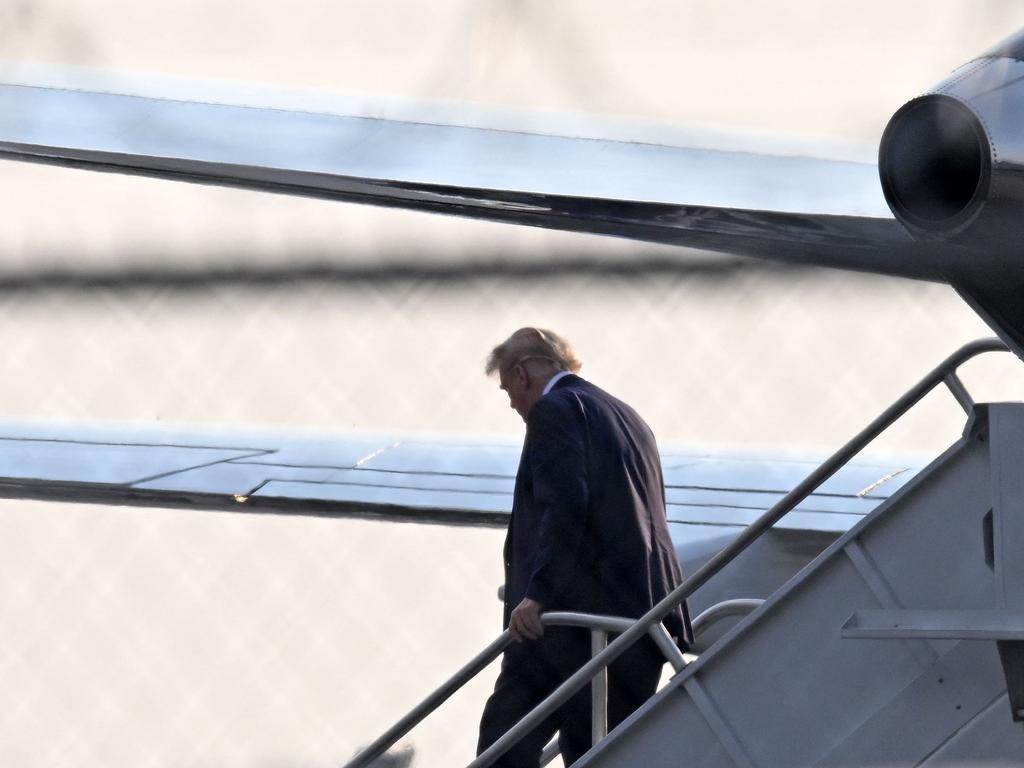 A downtrodden Donald Trump steps off his plane Trump Force One upon arrival at Atlanta Hartsfield-Jackson International Airport on his way to the Fulton County Jail in Atlanta, Georgia, on August 24, 2023. Picture: AFP.