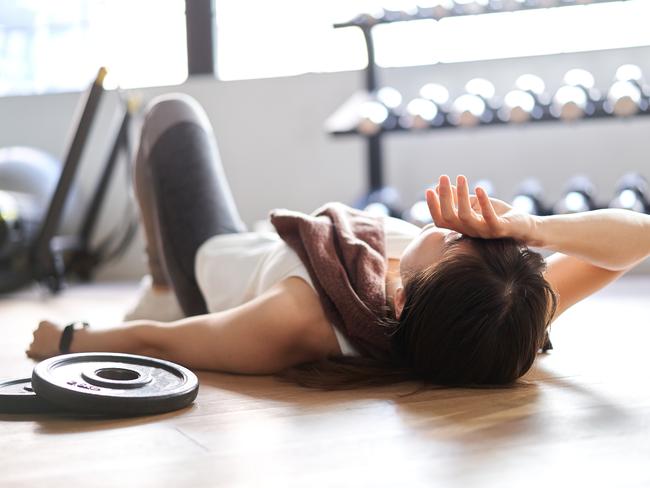 Asian woman lying down in the training gym