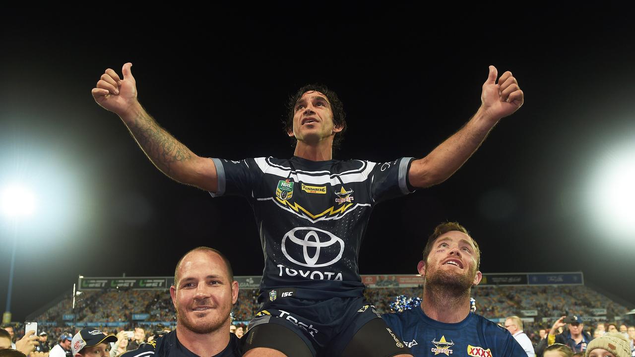 Johnathan Thurston is carried off the field by teammates Matt Scott and Gavin Cooper. Picture: Zak Simmonds