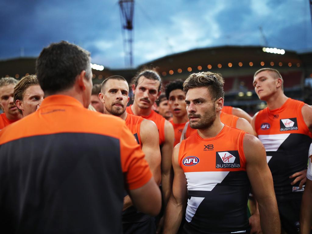 Players Brett Deledio, Phil Davis, Adam Tomlinson, Stephen Coniglio and team listen to coach Leon Cameron at quarter time. Picture: Phil Hillyard