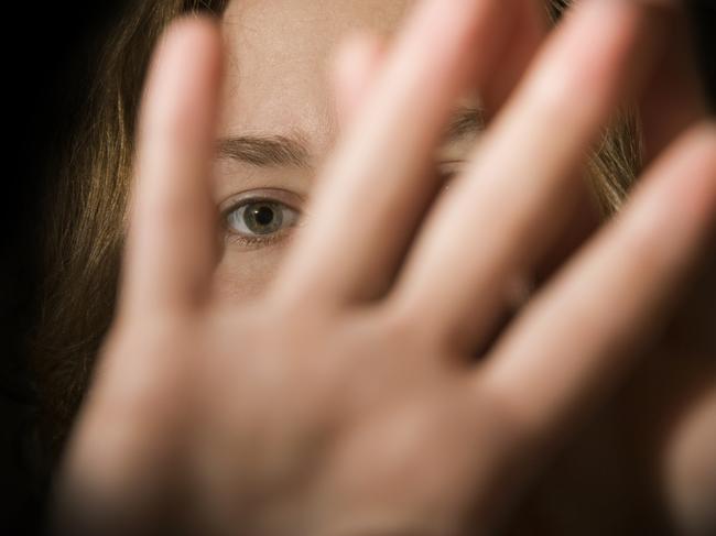 A woman's hands in front of her face. domestic violence generic