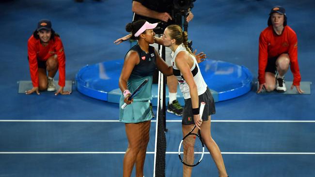 Osaka and Kvitovaembrace at the net after the match.