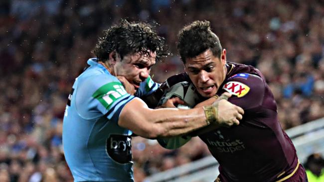 Dane Gagai tries to fight off the attention of James Roberts. Pic Annette Dew