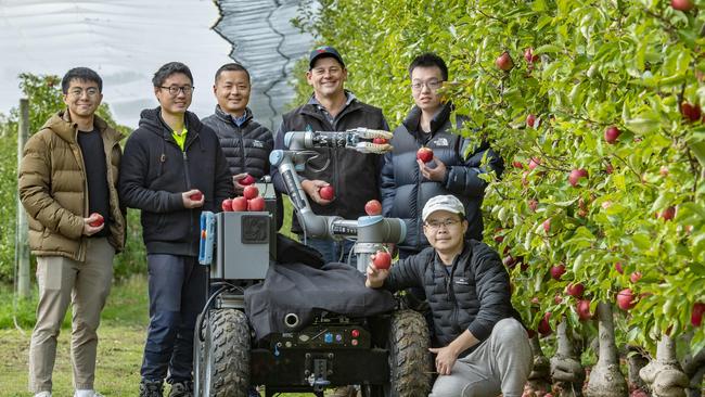 Brad and the Monash Uni robotics team responsible for the robot. Eugene Kok, Wesley Au, Chao Chen, Brad Fankhauser, Tianhao Liu, Hugh Zhou. Picture: Zoe Phillips