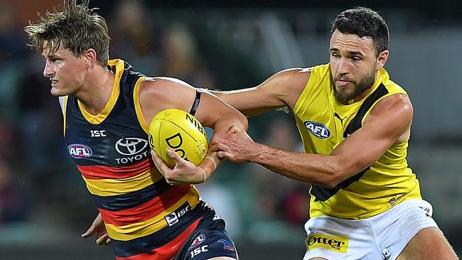 Adelaide’s Matt Crouch tries to escape from Richmond’s Shane Edwards. Picture: Mark Brake/Getty