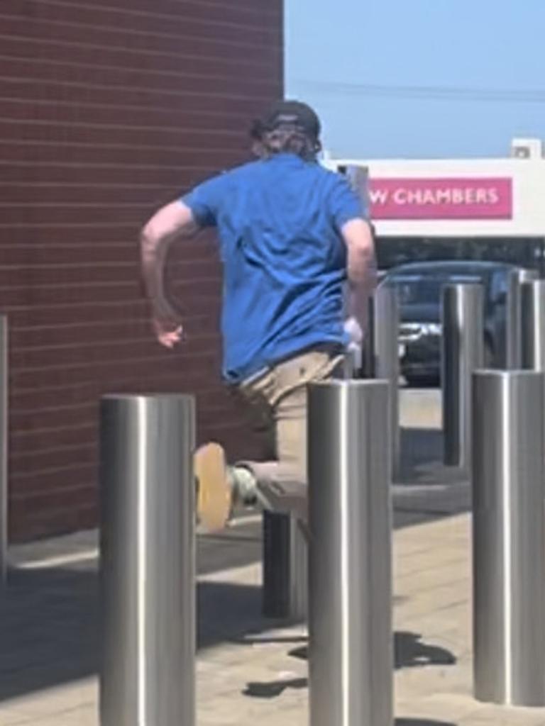 He sprinted down the side of a building into a carpark. Picture: Isabel McMillan