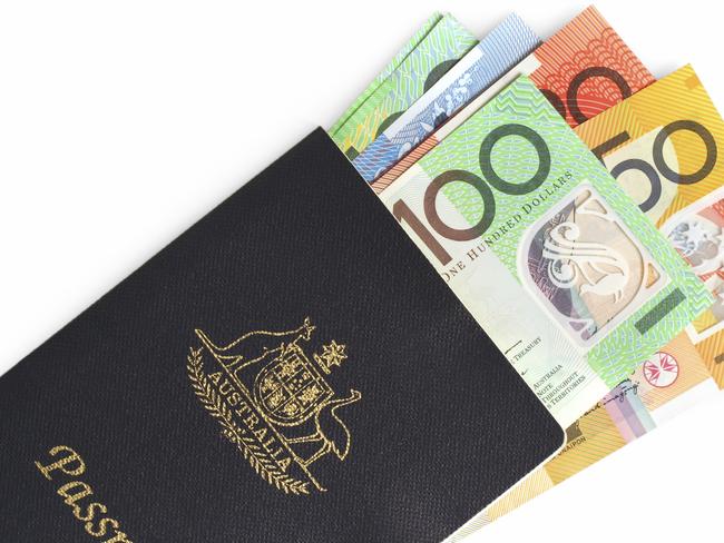 Australian passport with money tucked inside. Notes. Cash. $100. $50. $20. $10.