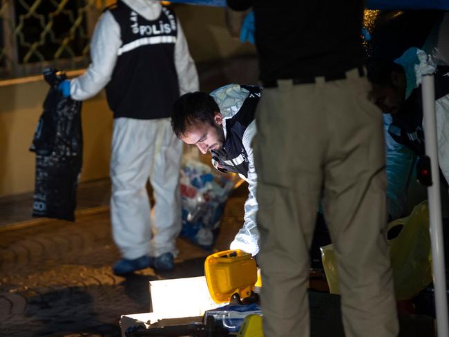 Turkish forensic police officers search for evidence as Saudi officials stand next to them at the Saudi Arabian consulate on October 17, 2018 in Istanbul. - Saudi Arabia's consul to Istanbul Mohammed al-Otaibion on October 16, 2018 left the Turkish city bound for Riyadh on a scheduled flight, reports said, as Turkey prepared to search his residence in the probe into the disappearance of journalist Jamal Khashoggi. (Photo by Yasin AKGUL / AFP)