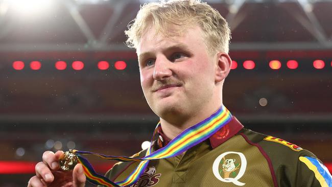 BRISBANE, AUSTRALIA - APRIL 25:  Tom Lynagh of the Reds hold the ANZAC medal after the round 11 Super Rugby Pacific match between Queensland Reds and Blues at Suncorp Stadium, on April 25, 2025, in Brisbane, Australia. (Photo by Chris Hyde/Getty Images)