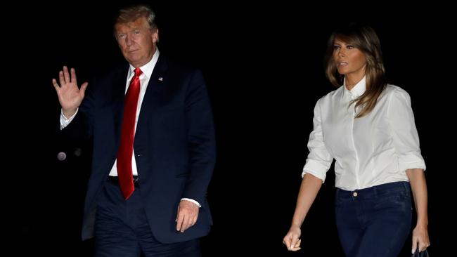 US President Donald Trump waves as he walks with first lady Melania Trump on the South Lawn of the White House. Picture: Reuters